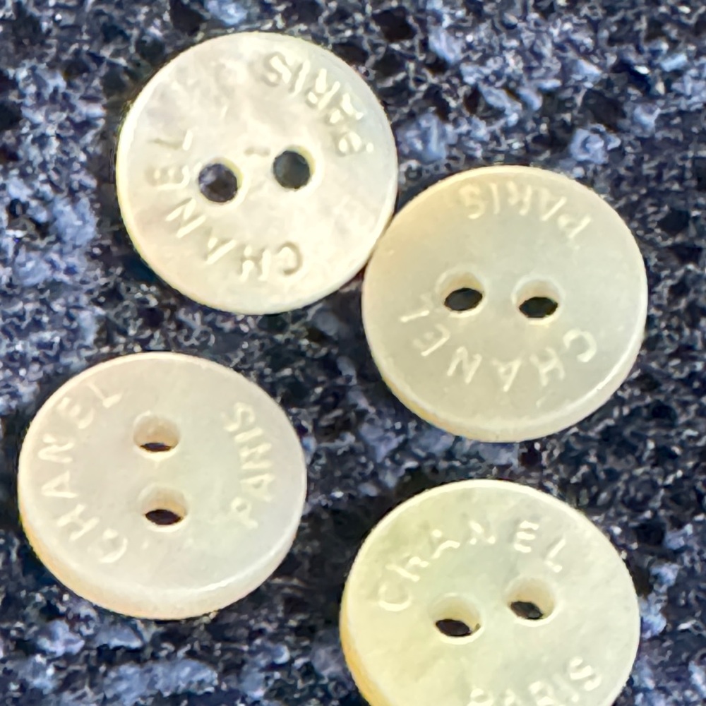 Chanel mother-of-pearl buttons. Just over 1/2”. 3 sets available.